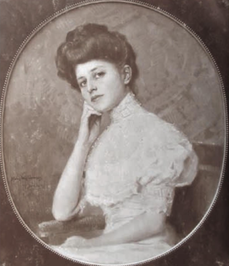 Eine junge Frau schaut um 1900 verträumt in die Kamera